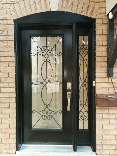 Single insulated steel entry front door with one sidelite. Black. Blackburn iron glass inserts. Porch enclosure main entrance